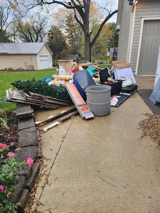 Dumpster being loaded with debris for Roofing Dumpster Rental in Newtown